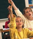 Elèves en classe levant la main.
